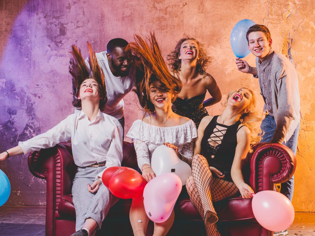 festive-men-women-holding-balloons
