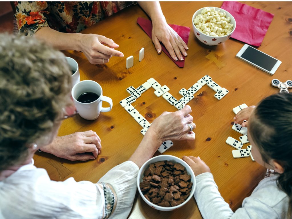 high-angle-view-family-playing-dominos-table